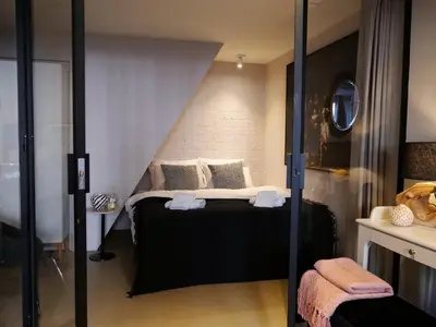a bedroom with a bed and a glass door at CANAL APARTMENT AMSTERDAM CENTRAL 4p in Amsterdam
