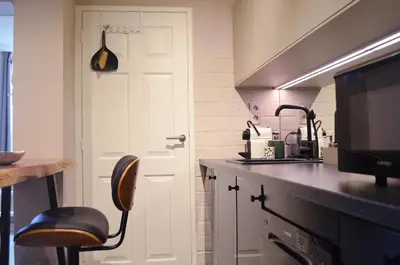 a kitchen with a white door and a chair in it at CANAL APARTMENT AMSTERDAM CENTRAL 4p in Amsterdam