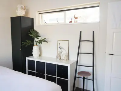 a bedroom with a black cabinet and a ladder at Karibu in Tuitjenhorn
