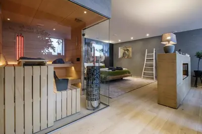 a living room with a glass wall at Bed & Wellness De Leilinde in Nieuwe-Niedorp