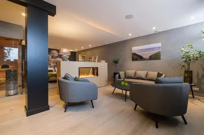 a living room with a couch and a fireplace at Bed & Wellness De Leilinde in Nieuwe-Niedorp