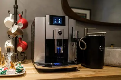 a coffee machine sitting on a counter with a plate of food at Bed & Wellness De Leilinde in Nieuwe-Niedorp