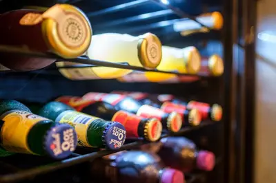 a row of wine bottles on a shelf at Bed & Wellness De Leilinde in Nieuwe-Niedorp