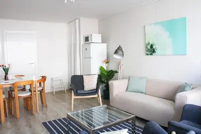 a living room with a couch and a table at Strandlicht in Egmond aan Zee