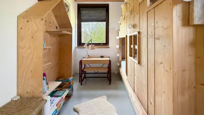 a tiny house with wooden walls and a table at Het Duinhuisje by Droomvilla in Egmond aan den Hoef