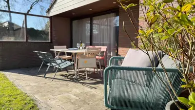a patio with a table and chairs on a patio at Het Duinhuisje by Droomvilla in Egmond aan den Hoef