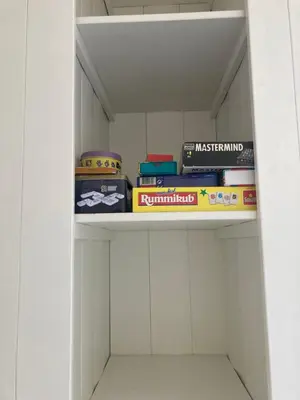 a book shelf with toys and books on it at Close to the beach modern appartement Oranje Boven in Zandvoort