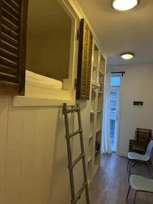 a ladder in a room with a bunk bed at Close to the beach modern appartement Oranje Boven in Zandvoort