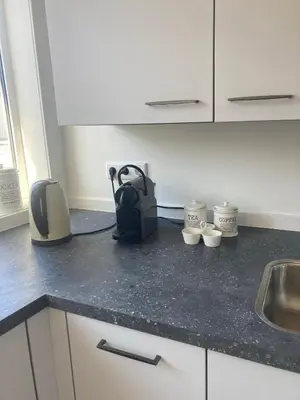 a kitchen counter with a sink and a bag on it at Close to the beach modern appartement Oranje Boven in Zandvoort