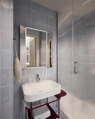 a bathroom with a white sink and a mirror at Conscious Hotel Oudegracht in Utrecht