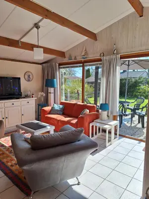 a living room with a couch and a table at Rekerlanden 210 in Schoorldam