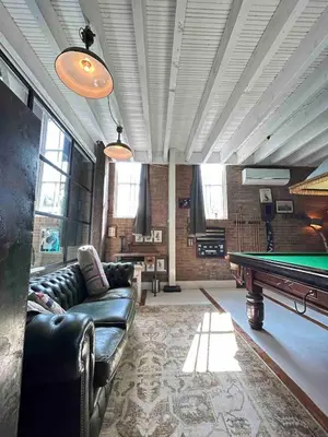 a living room with a pool table in it at Sfeervol Overnachten in de Kerk in Amersfoort