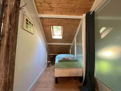 a small room with a stairs with a bed in it at Sfeervol Overnachten in de Kerk in Amersfoort