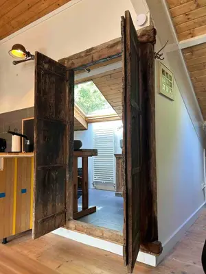 an open door into a kitchen with a table at Sfeervol Overnachten in de Kerk in Amersfoort