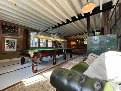 a living room with a pool table and a couch at Sfeervol Overnachten in de Kerk in Amersfoort