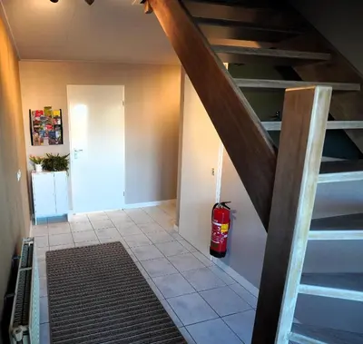 a room with a staircase and a fire extinguisher at De Sas in Lisse in Lisse