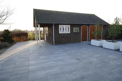a house with a large patio in front of it at De Sas in Lisse in Lisse