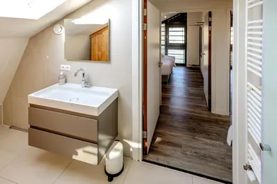a bathroom with a sink and a mirror at Villa Koperwiek in Egmond aan den Hoef