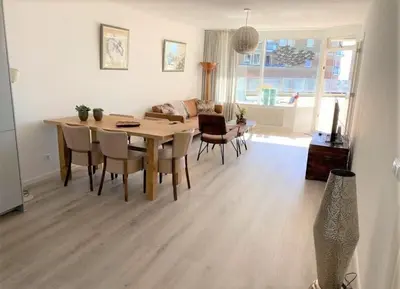 a living room with a wooden table and chairs at Sterflat 33 - 