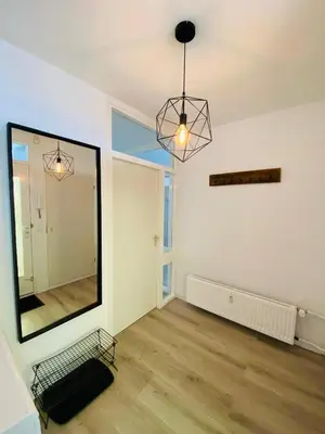 an empty room with a large mirror and a chair at Sterflat 33 - 