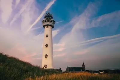 a white lighthouse sitting on top of a hill at Sterflat 33 - 