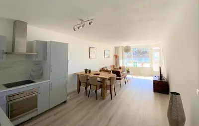 a kitchen and dining room with a table and chairs at Sterflat 33 - 