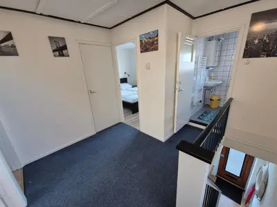 a room with a hallway with a bedroom at De Groten Zes in Egmond aan Zee