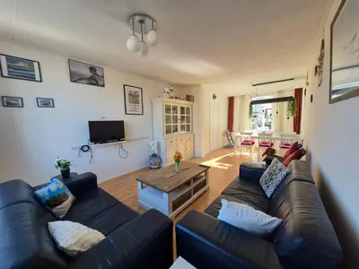 a living room with a couch and a table at De Groten Zes in Egmond aan Zee