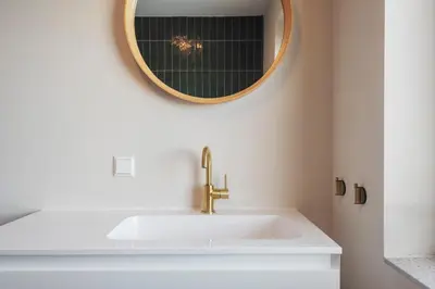a bathroom with a sink and a mirror at Coastal Inn in Zandvoort
