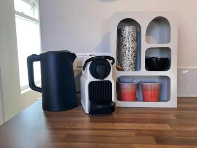 a coffeemaker sitting on a table next to a coffee maker at Salty Breeze in Noordwijk