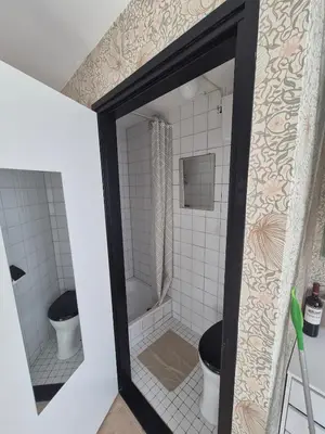 a bathroom with two toilets and a mirror at Vlier aan zee in Katwijk aan Zee