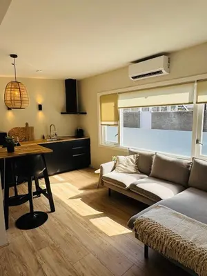 a living room with a couch and a table at Willem's Beachhouse in Noordwijk