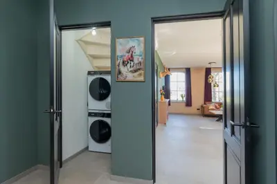 a laundry room with a washer and dryer at Villa Meer en Duin in Noordwijkerhout