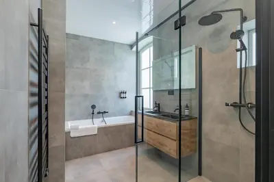 a bathroom with a tub and a sink and a shower at Villa Meer en Duin in Noordwijkerhout