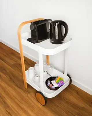 a white shelf with a coffee maker on it at Limehome Utrecht Balijelaan in Utrecht