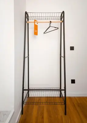 a metal rack with an orange tag on a wall at Limehome Utrecht Balijelaan in Utrecht
