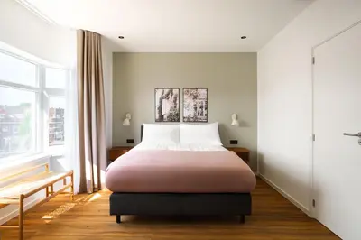 a bedroom with a bed and a window at Limehome Utrecht Balijelaan in Utrecht