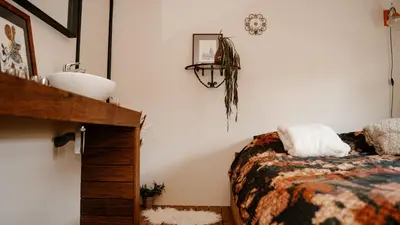 a bedroom with a bed and a sink in it at de Bunker Katwijk in Katwijk