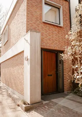a brick building with a wooden door on it at de Bunker Katwijk in Katwijk