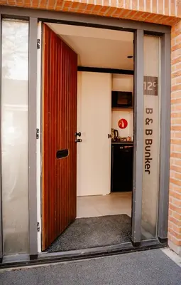 an open door to a kitchen in a building at de Bunker Katwijk in Katwijk