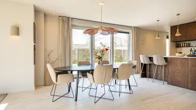 a kitchen and dining room with a table and chairs at Villa Endless Summer in Bergen