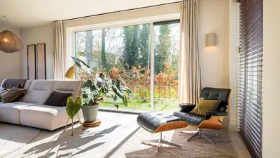a living room with a couch and a large window at Villa Endless Summer in Bergen