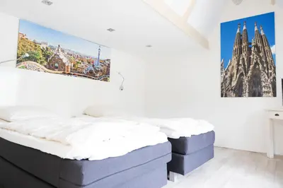 a bedroom with two mattresses and a painting on the wall at La Casita bed and breakfast in Voorschoten