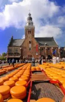 a large building with a bunch of orange benches at Huisje Suus, inclusief jacuzzi, kano en kajak in Zuid-Scharwoude