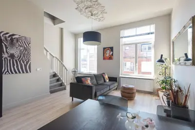 a living room with a couch and a table at De Sonnehoeck Zandvoort in Zandvoort