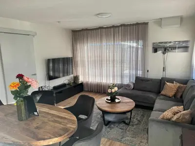 a living room with a couch and a table at Casa Freddy in Noordwijkerhout