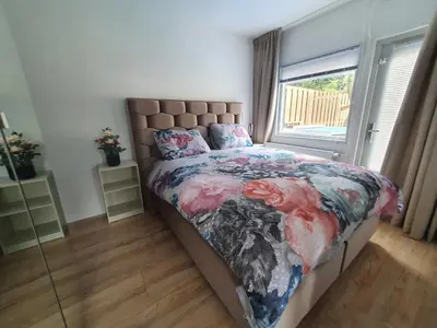 a bedroom with a bed with a large window at Casa Freddy in Noordwijkerhout