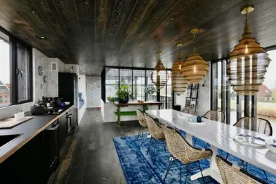 a kitchen with a long table and some chairs at Hidden Gem in Oost-Knollendam
