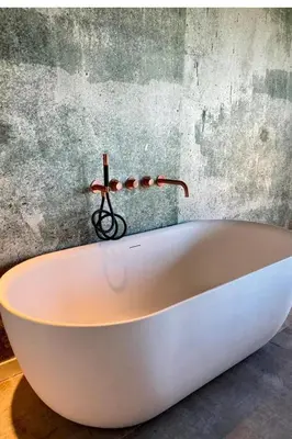 a white bath tub sitting in front of a wall at Hidden Gem in Oost-Knollendam