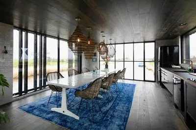 a dining room with a white table and chairs at Hidden Gem in Oost-Knollendam